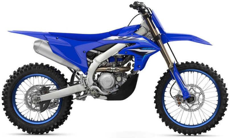 Yamaha YZ450FX dirt bike with blue and white bodywork, front suspension, knobby tires, and racing graphics.