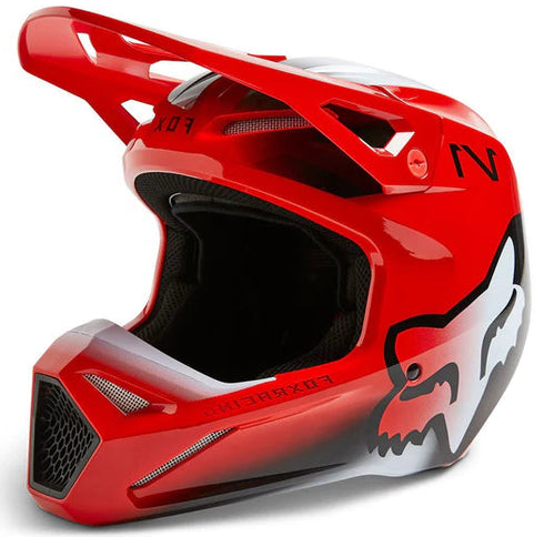 FOX V1 TOXSYK youth MX helmet in vibrant FLO RED with black accents, featuring ventilation and adjustable straps.