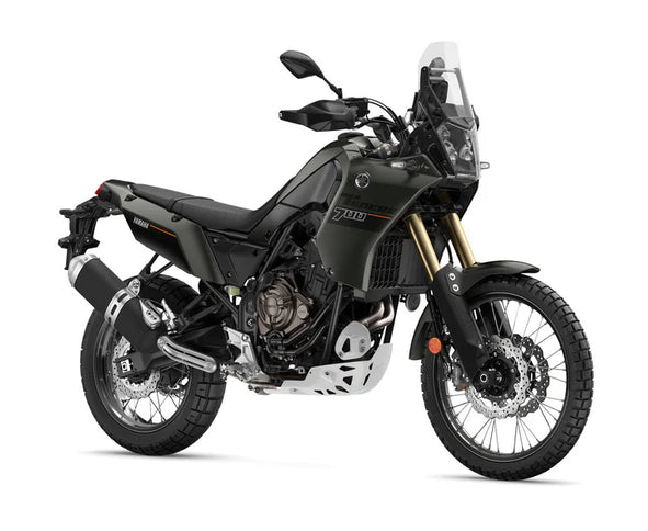 Yamaha Ténéré 700 adventure motorcycle parked on a scenic trail with rugged terrain and clear blue sky in the background.