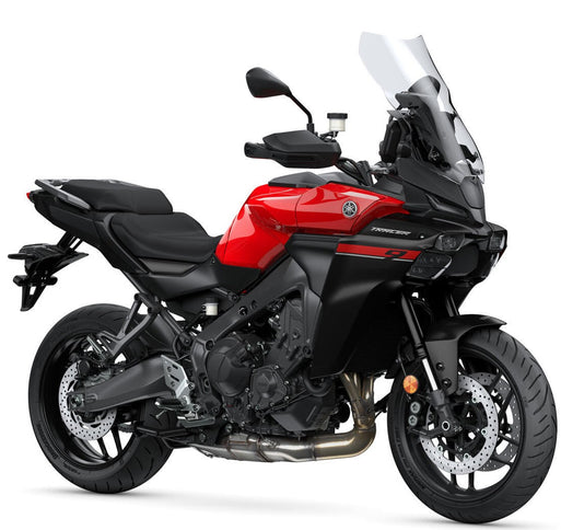 Red Yamaha Tracer 900 sports touring motorcycle, front and side view with sleek design and vibrant red color.