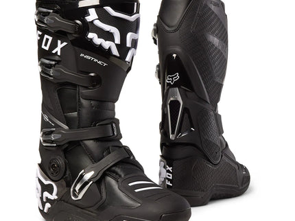 Black FOX Instinct MX boots with sturdy ankle protection and adjustable straps, designed for motocross riding.
