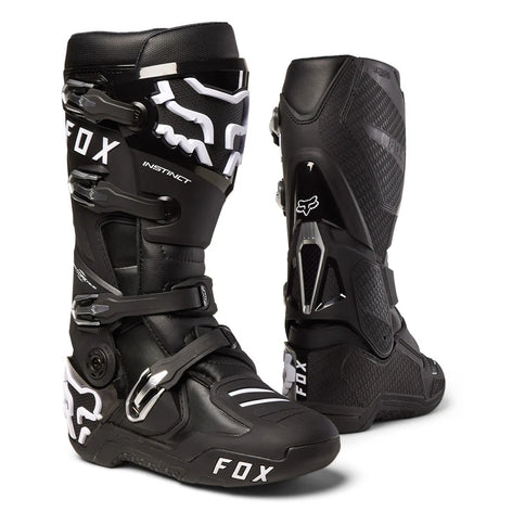 Black FOX Instinct MX boots with sturdy ankle protection and adjustable straps, designed for motocross riding.