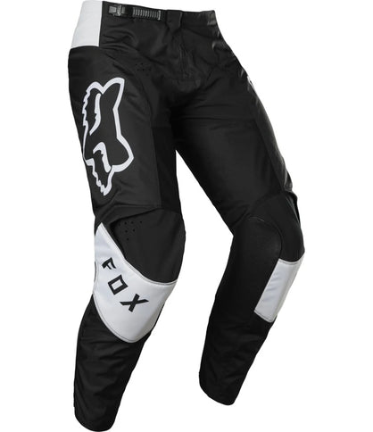 Black and white MX FOX 180 Lux Pants with adjustable waistband and reinforced knees, designed for motocross riding.