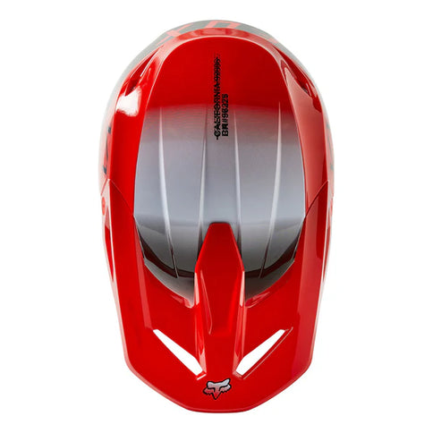 FOX V1 TOXSYK Youth MX helmet in vibrant FLO RED with adjustable chin strap and ventilation for motocross riding.