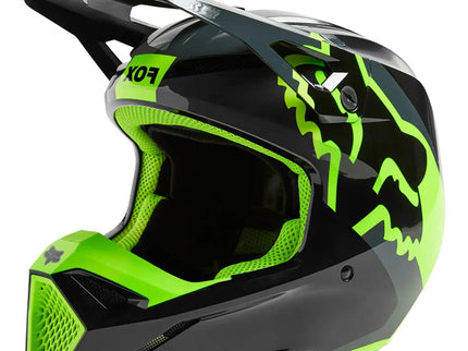 Fox Racing V1 XPOZR MX helmet in black and grey with yellow accents, featuring aerodynamic design and ventilation for motocross riding.