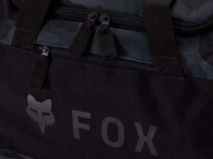 FOX 180 Duffle Gear Bag in black camo, a durable kit bag with adjustable straps and spacious main compartment for travel or sports use.