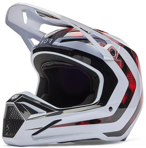 White FOX V1 KAIROS MX helmet with red and black accents, lightweight design, and aerodynamic vents for motocross riding.