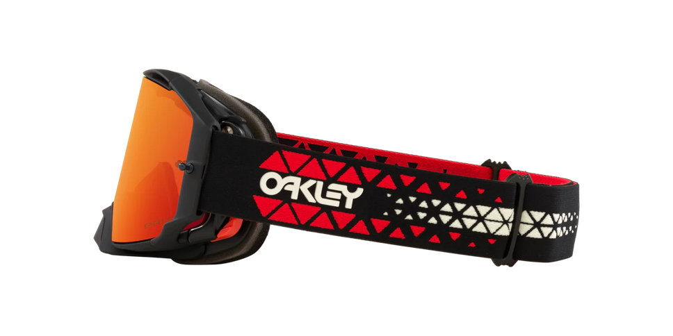 Oakley AIRBRAKE MX goggles with Prizm Torch lens, featuring adjustable strap and protective case for motocross riding.