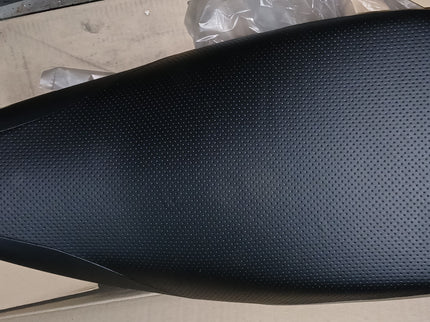 Yamaha YFM80 single seat part, black and shaped for off-road vehicle, with visible mounting points and foam padding.