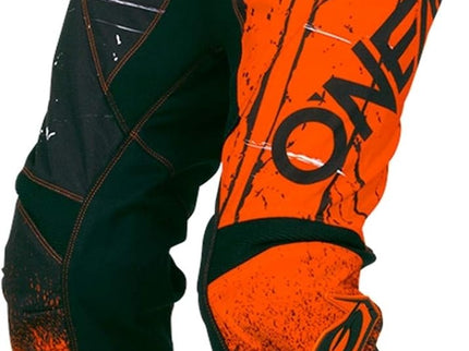 Orange ONEAL MX Shred motocross pants with black accents, designed for off-road riding and durable performance.