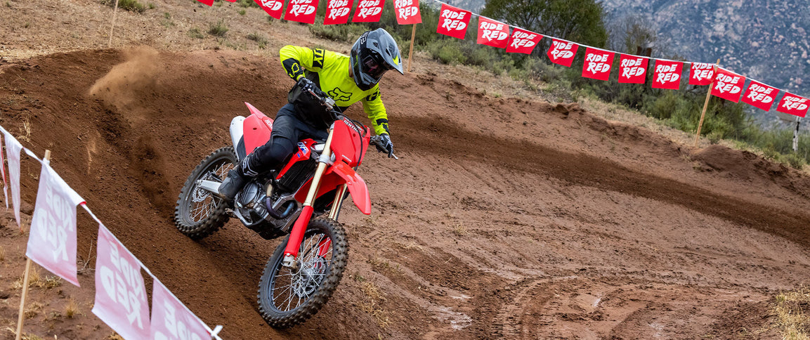 Honda CRF450R dirt bike shown in a side view with detailed engine and sporty design, ready for off-road riding.