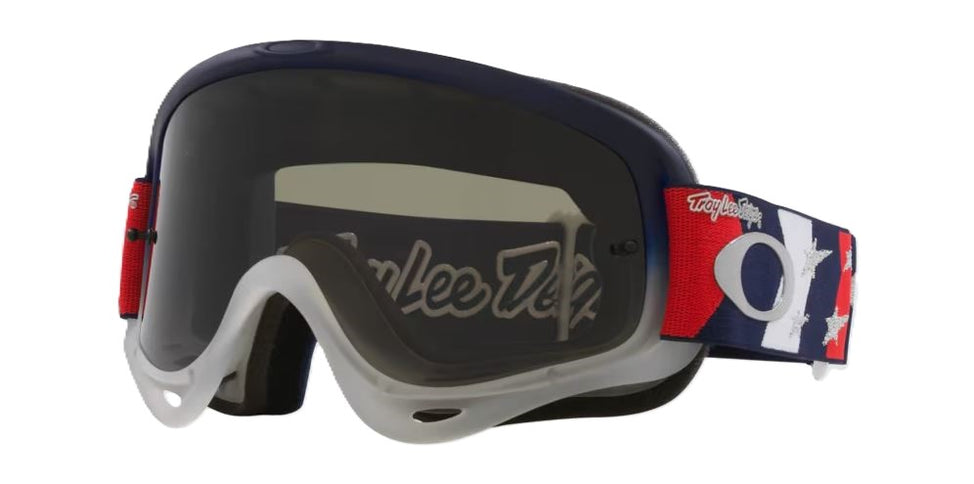 Oakley O Frame MX goggles with red, white, blue stars design and dark gray lens, designed for motocross riding.