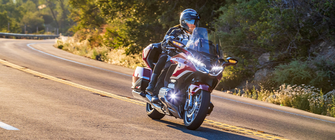 Honda Goldwing GL1800ABS motorcycle with sleek gold finish and touring design, shown from the side view.
