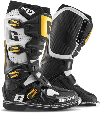 Black and white Gaerne SG12 Luxe MX boots with gold accents, featuring sturdy construction and premium branding for motocross riding.