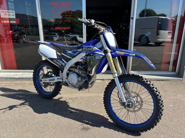 Used 2021 Yamaha YZ 450 F dirt bike with black and white bodywork and off-road tires, ready for motocross riding.