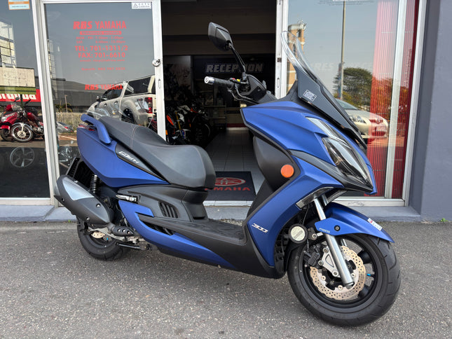 Used 2022 Kymco G Dink 300i scooter, black and silver, showing front view with handlebars and headlight.