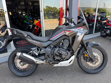 Used Honda 2026 Transalp 750 E clutch demo bike, showing the motorcycle's handlebar and front view.