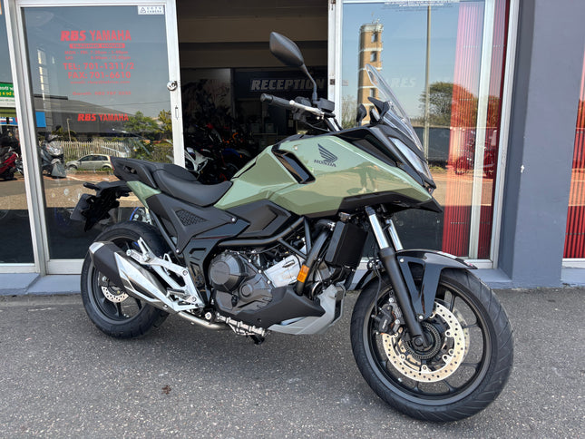 Used 2026 Honda NC 750X demo motorcycle, black and silver, with sleek design and digital display, photographed from the side.