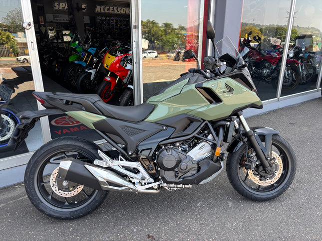 Used 2026 Honda NC 750 X demo motorcycle, with black body and sporty design, shown from side angle.