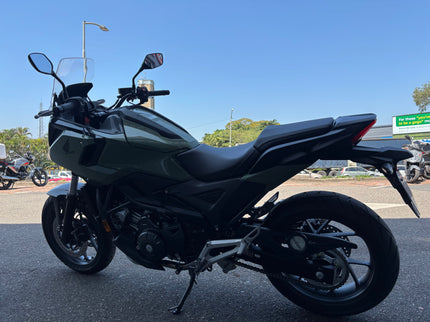 Used 2026 Honda NC 750X demo motorcycle, black and silver, with sleek design and riding features, photographed from the side.