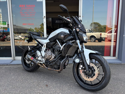 Used 2014 Yamaha MT 07 motorcycle, black sport bike with sleek design, visible engine and sporty handlebars.