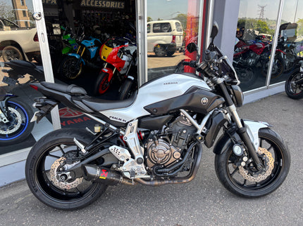 Used 2014 Yamaha MT 07 motorcycle with black and silver body, front view showing handlebars and headlight.
