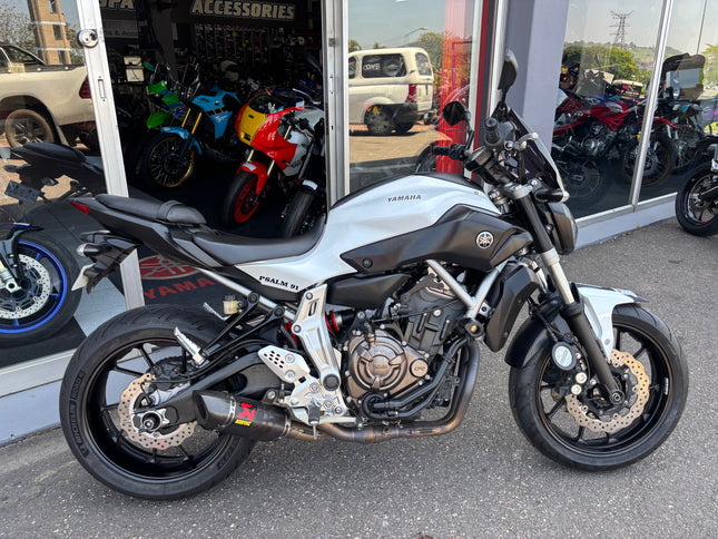 Used 2014 Yamaha MT 07 motorcycle with black and silver body, front view showing handlebars and headlight.