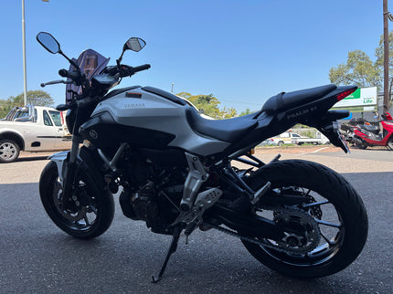 Used 2014 Yamaha MT 07 motorcycle, black and silver sporty bike with sleek design, side view image.