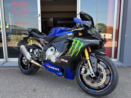 Used 2015 Yamaha YZF R1 M motorcycle, blue sport bike with sleek design and racing features, from a side view.