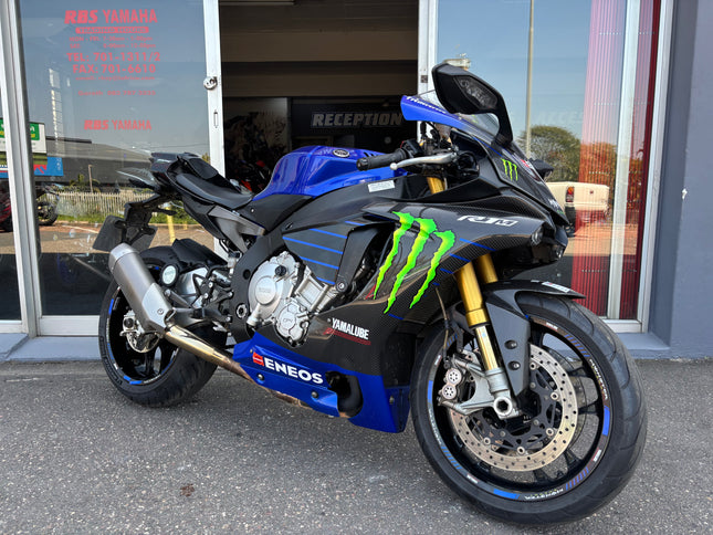 Used 2015 Yamaha YZF R1 M motorcycle, blue sport bike with sleek design and racing features, from a side view.