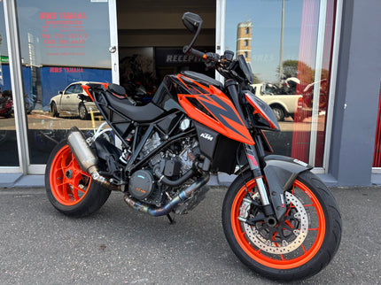Used Yamaha motorcycle, 2019 KTM 1290 Superduke model, black and orange bike with sporty design and aggressive stance.