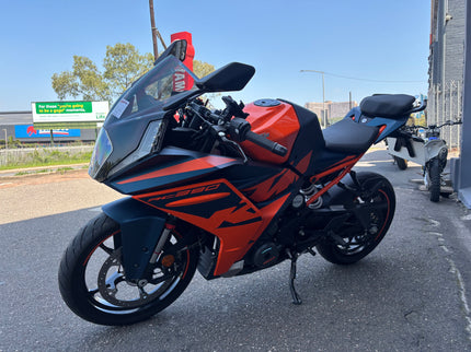 Used Yamaha 2024 KTM RC 390 motorcycle, side view showing sporty design and black and orange color scheme.
