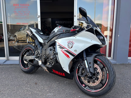 Used 2014 Yamaha YZF R1 motorcycle with sleek black body and sporty design, showcased in a side view.