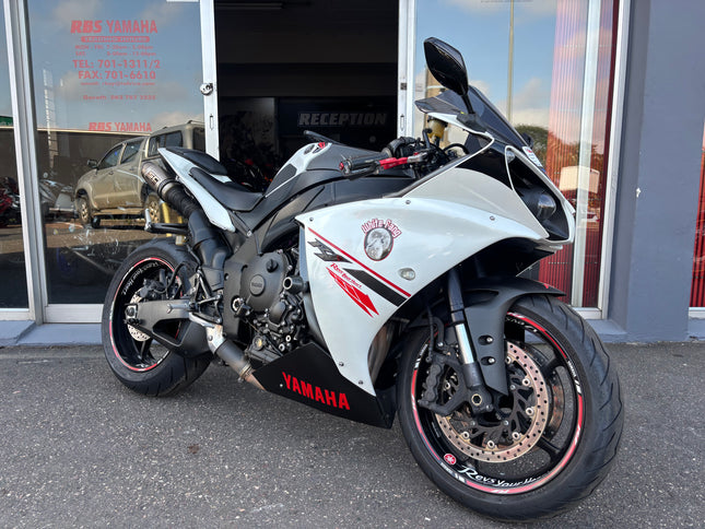 Used 2014 Yamaha YZF R1 motorcycle with sleek black body and sporty design, showcased in a side view.