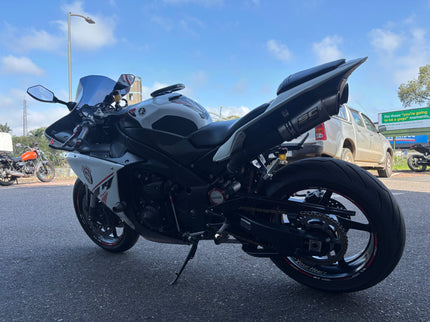 Used 2014 Yamaha YZF R1 motorcycle, black sportbike with sleek fairings and aggressive riding position.