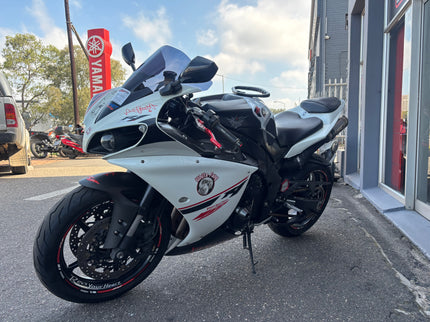 Used 2014 Yamaha YZF R1 motorcycle with sleek black body and sporty design, photographed from the side.