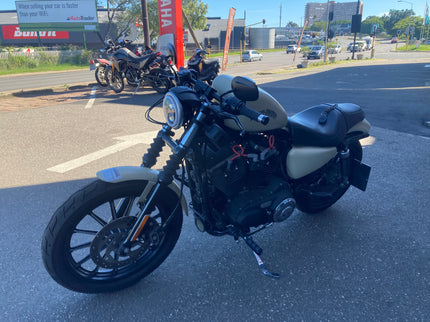 Used 2014 Harley Davidson Sportster 883 Iron motorcycle with black finish and classic cruiser style.