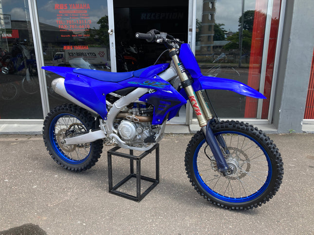 Used 2024 Yamaha YZ 450 F dirt bike with blue frame and aggressive tires, showcasing the off-road motorcycle's sporty design.