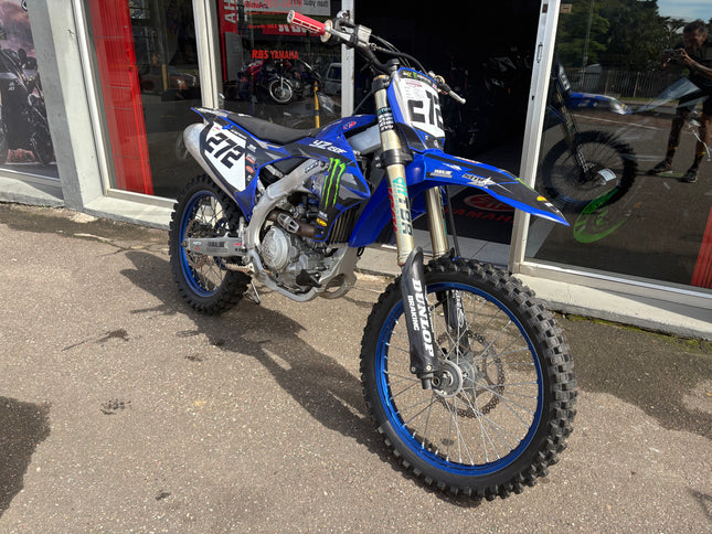 Used 2024 Yamaha YZ 450 F dirt bike with off-road tires and sporty design, showcased in a dynamic riding position.