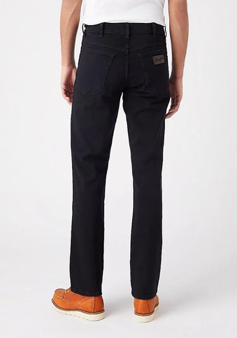 Black Wrangler Texas Stretch Jeans by PRO with classic fit and denim texture, shown on a plain background.