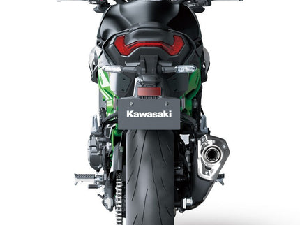 Kawasaki Z900 ABS naked motorcycle parked on a city street, showcasing its sleek black design and modern styling.