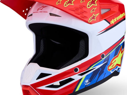 Alpinestars S-M3 Falcon youth motocross helmet in red, white, and blue with a secure strap and ventilation system.