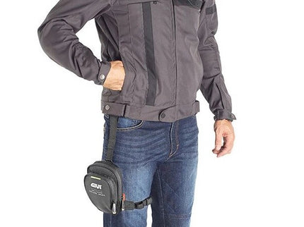 GIVI leg bag attached to motorcycle rider's leg, made of durable material with adjustable straps for carrying essentials.
