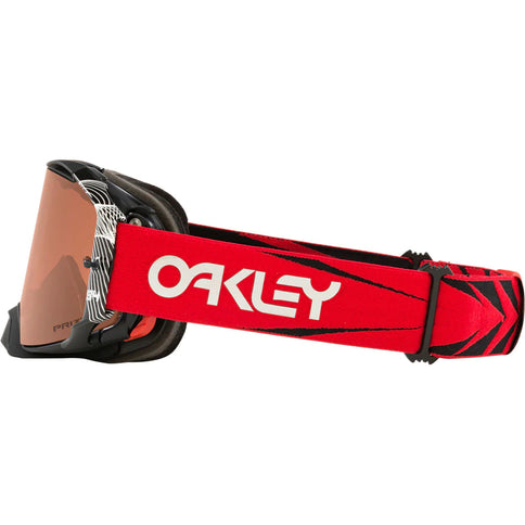 Oakley AIRBRAKE MX goggles from Herlings Signature Series with red Prizm lenses and protective case on a neutral background.