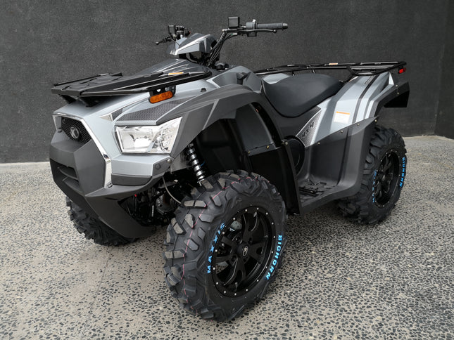 KYMCO MXU 700 all-terrain vehicle with rugged tires and green body, designed for off-road adventures.