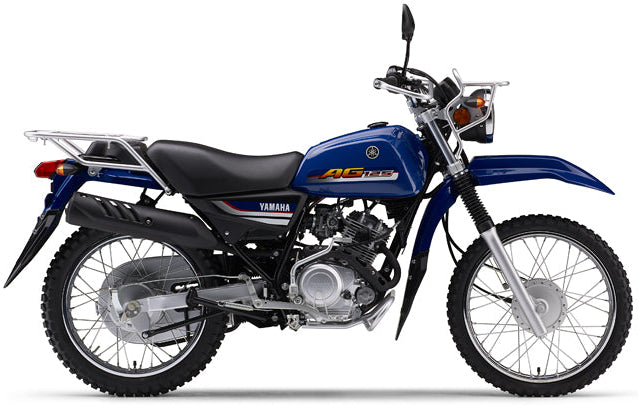 Yamaha AG125 motorcycle with black and silver body, featuring a compact design and front headlight, parked outdoors.