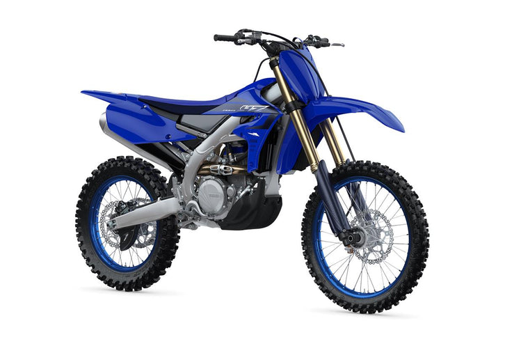 Yamaha YZ450FX 2025 dirt bike in red and black, with rugged tires and racing-style design, shown from side view.