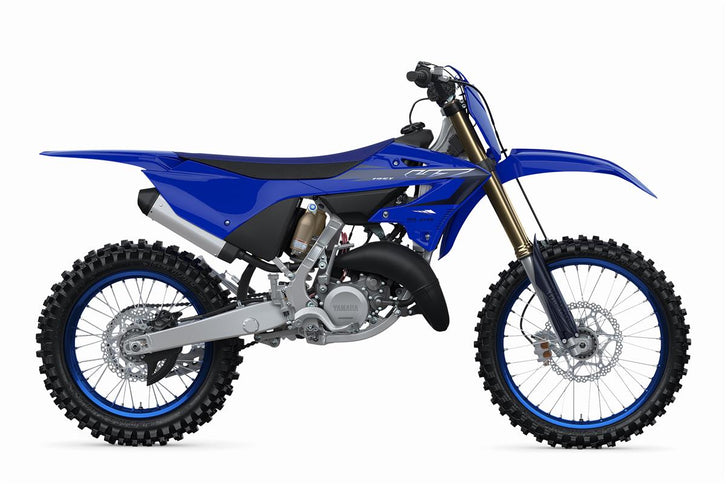YAMAHA YZ125 X dirt bike with blue and white bodywork, knobby tires, and racing suspension, shown from side view.
