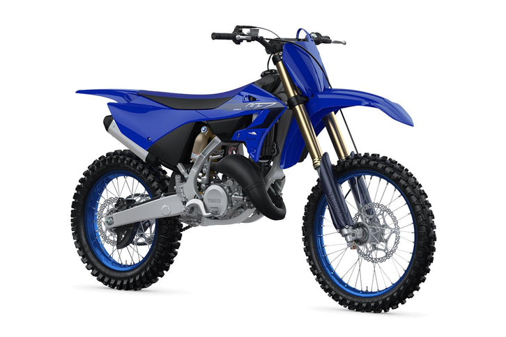 YAMAHA YZ125 X dirt bike with blue and white body, knobby tires, and racing graphics on a riding track.