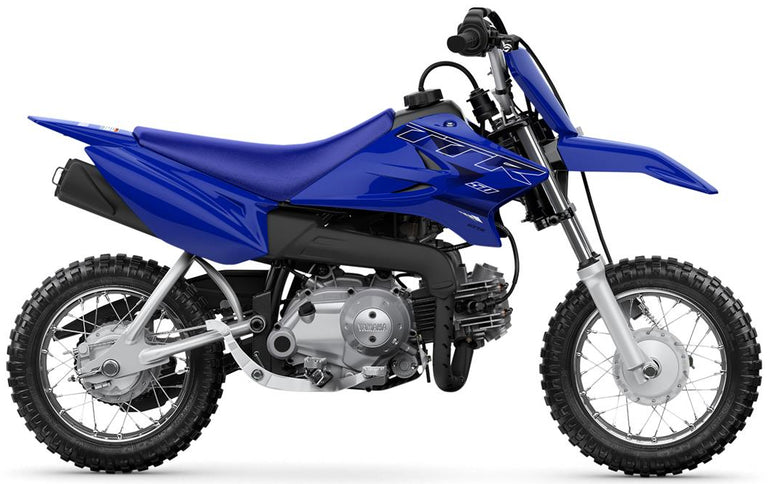 Yamaha TTR50E off-road mini motorcycle with knobby tires, black frame, and colorful graphics for young riders.